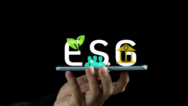 Human hand showing his smartphone with ESG icon. Net zero greenhouse gas emissions target. Climate neutral long term strategy. Ecological, renewable energy and save environment concept.
