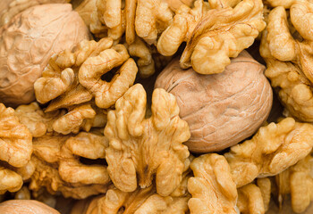 background of peeled and unpeeled walnut. top view