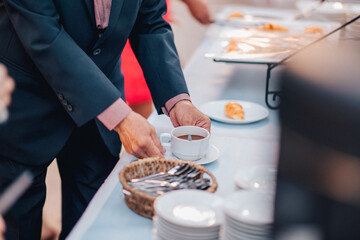 waiter serving tray of food