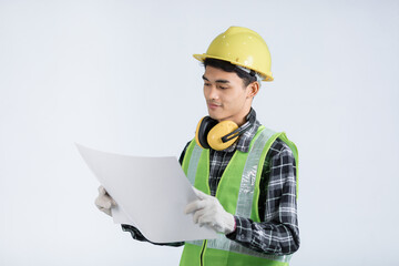 Young asian engineer in light green protective suit wearing yellow hat wearing white gloves yellow headphones holding document happy gesture checking work white background design
