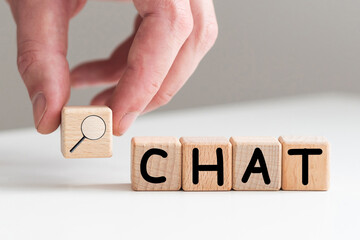 In the man's hand are cubes with the inscription - CHAT.