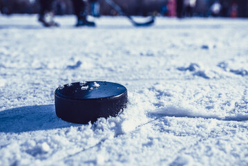 hockey puck lies on the snow macro
