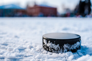hockey puck lies on the snow macro