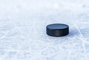 hockey puck lies on the snow close-up - obrazy, fototapety, plakaty