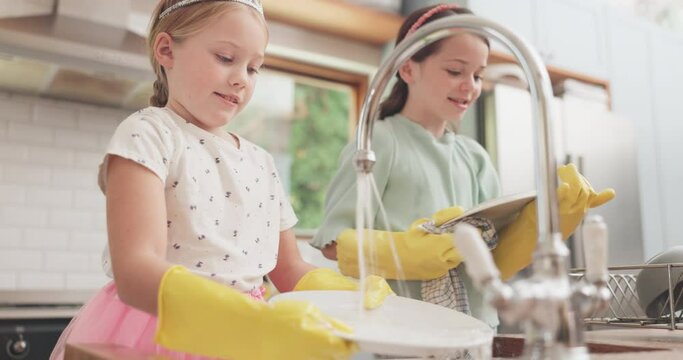 Water, cleaning and children learning with dishes in kitchen or sister, girl or helping to wash, dry and clean house. Kids, washing and cloth to wipe plates, cutlery or family home housework