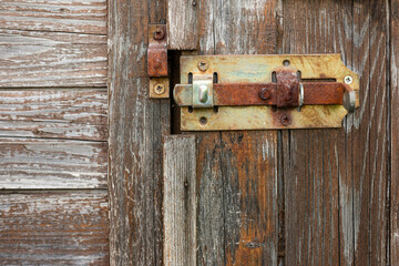 Hinges, latch, Lock on an old wooden shed with weathered wood textured background