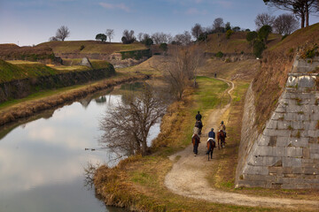 Horseback riders gracefully explore Palmanova's bastions