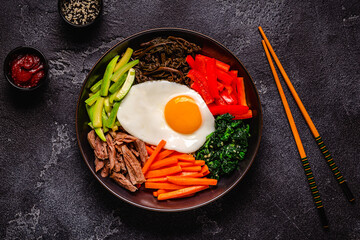 Traditional Korean dish Bibimbap: rice with vegetables beef and egg.