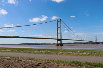 The Humber Bridge crossing the estuary at Kingston-upon-Hull, England, A single-span road suspension bridge at low tide.