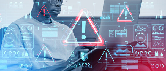 African man working with computer, system attack hologram with glowing icons