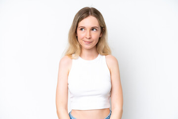 Blonde English young girl isolated on white background having doubts while looking up