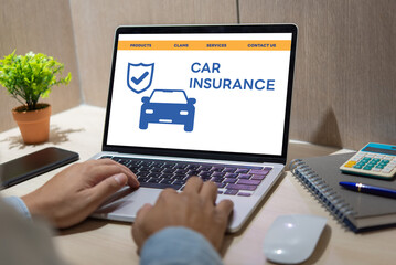 person using a laptop device to access an online car insurance platform customers can compare quotes, With this innovative solution, file claims, and access roadside assistance right.