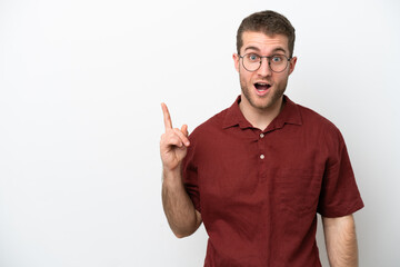 Young caucasian man isolated on white background thinking an idea pointing the finger up