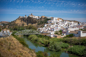 Fototapeta na wymiar Panoramic view of the southern part of Arcos de la Frontera, Cadiz, Andalusia, Spain, with the churches on top, and a new bridge over the river