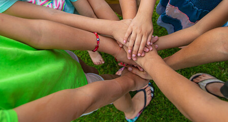 Fototapeta premium The children put their hands together. Selective focus.