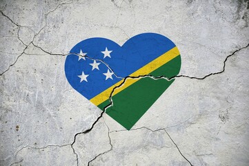The symbol of the national flag of Solomon Islands in the form of a heart on a cracked concrete...
