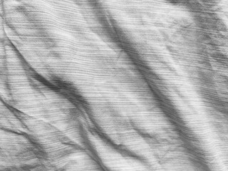 Gray crumpled linen fabric as a background, texture, full frame. Natural linen organic eco textiles canvas background. Bed linen in soft folds. Top view. Selective focus.