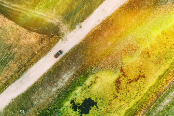 Aerial View Of Car SUV Parked Near Countryside Road, Summer Field Rural Landscape near bog marsh swamp.