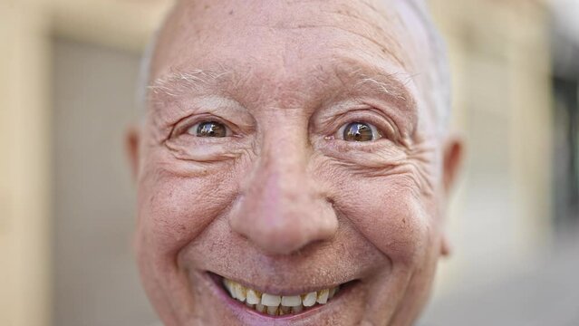 Senior grey-haired man smiling confident standing at street