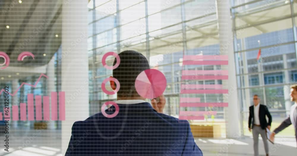 Poster animation of data processing over rear view of biracial businessman talking on smartphone at office