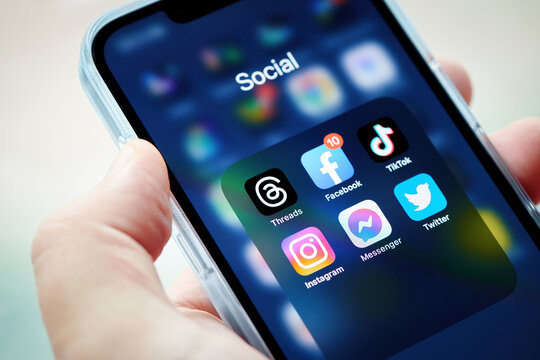 Moscow, Russia, 08-07-2023: Threads app icon on smartphone screen with other social media apps. Man arm hold smartphone to run Threads app. Threads social media network. Shallow DOF