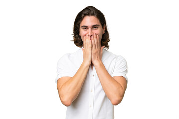 Young caucasian man isolated on green chroma background happy and smiling covering mouth with hands
