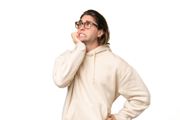 Young caucasian man isolated on green chroma background is a little bit nervous