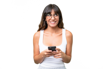 Young caucasian woman over isolated background using mobile phone and looking up