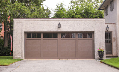 garage door stands as a gateway of privacy and utility, symbolizing security, shelter, and the hidden narratives within a home