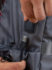 close up of the usb connector in a gray backpack, bag