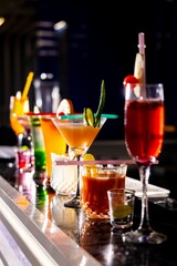 Cocktail Glasses on Dark background. Party mood, International Luxury Hotels, Pubs, Restaurants Bar counter 