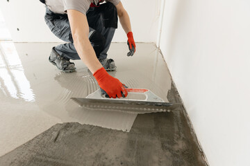 Screed concrete with self leveling cement mortar for floors. Master work renovation home