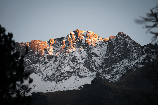 The last light of the day shines on the Saoseo Peaks at sunset, in Switzerland