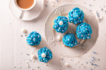 Delicious and sweet cupcakes with blue whipped cream.