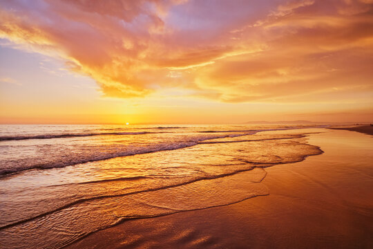 Atlantic ocean sunset with surging waves at Fonte da Telha beach, Costa da Caparica, Portugal