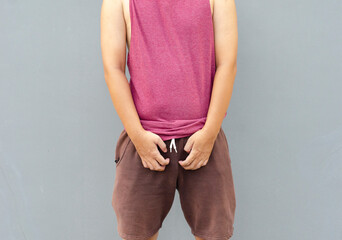 Asian man scratching itch with hand on genital area, health care concept