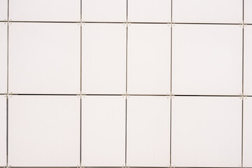 wall texture with tiles of different colors on the facade of the building