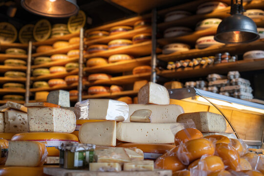 Dutch cheese edam gouda piece and whole round wheel in cheese store. Netherlands gastronomic tourism