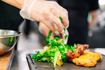 woman chef hand cooking grilled meat with baked potatoes and salad