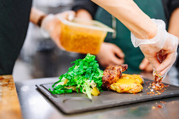 woman chef hand cooking grilled meat with baked potatoes and salad