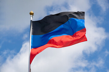 Flags of Russia, Donetsk People's Republic. The Donetsk and People's Republics are partially recognized state entities in Eastern Europe. Flag on blue sky background