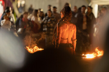 A woman performing a fire show at the street