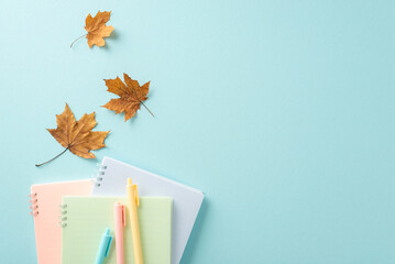 Back to school concept. High angle view creative photo featuring colorful notebooks and pens with...