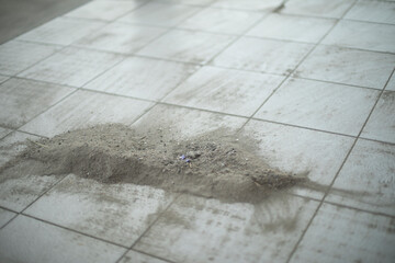 Dust on tiles. Sand cleaning. Swept away garbage.
