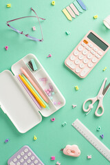 Colorful back-to-school assortment. Vertical top view of feminine stationery, pencil case, pens,...