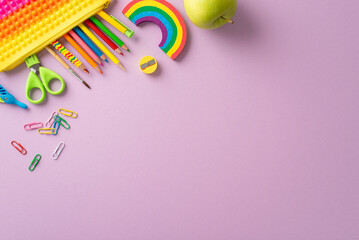 Immerse in joy of learning for young learners through this top view snapshot: a vibrant compilation of child stationery against violet isolated background, providing copyspace for text or promotion