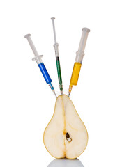 A pear with a syringe filled with chemicals