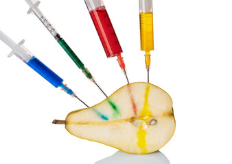 A pear with a syringe filled with chemicals