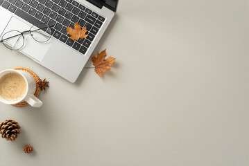 Autumn-inspired office theme. Top view of laptop, steaming mug of pumpkin spice latte, stylish...