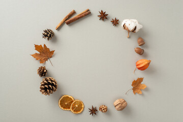 Autumnal attributes concept. Above view photo of cinnamon sticks, chinese anise, dried oranges,...
